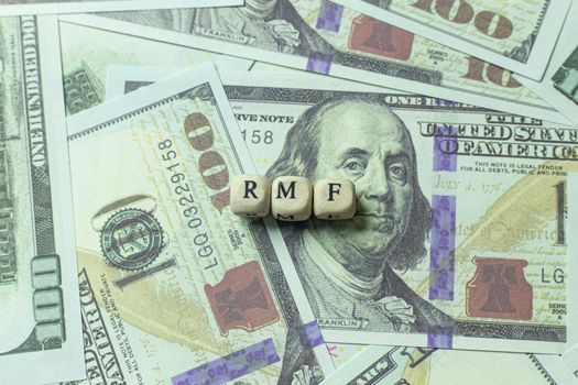 The rmf wooden cube on banknotes for business content.