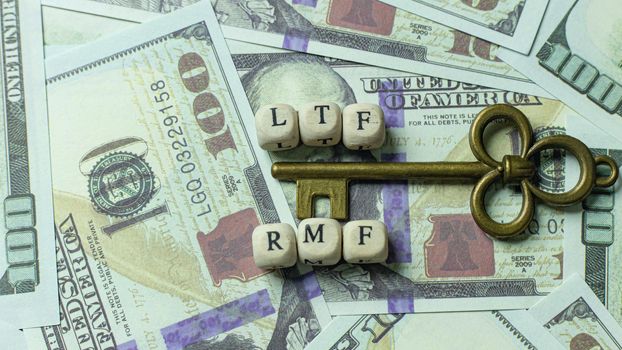 The ltf and rmf   wooden cube  gold key vintage on banknotes for business content.