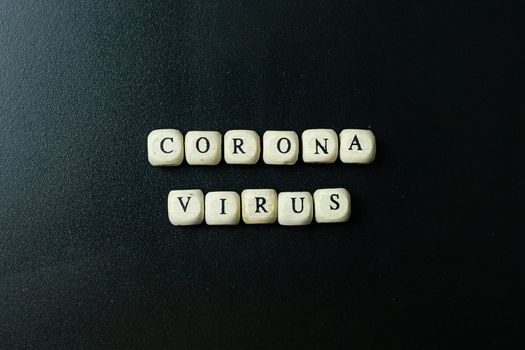 The corona virus  wooden cube  on black background for medical content.