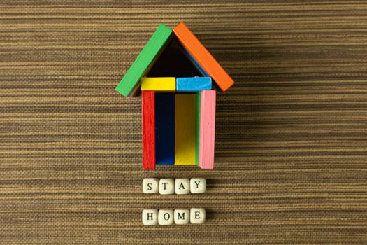 The stay home on wood cube and home toy for social distancing content.