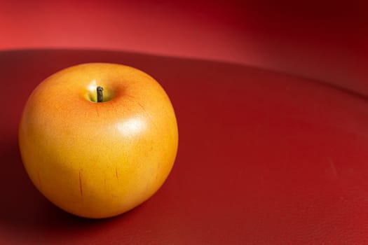 A apple on red background low light for food content.
