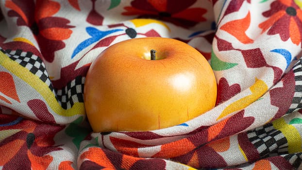 A apple on scarf low light for food content.