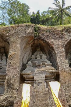 Candi (shrines) carved into a rock in a valley by the Pakerisan River. Gunung Kawi is an 11th-century temple and funerary complex in Tampaksiring northeast of Ubud in Bali, Indonesia.