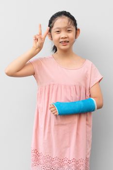Asian Child with Broken Arm in Cast with Smiling Face Expression