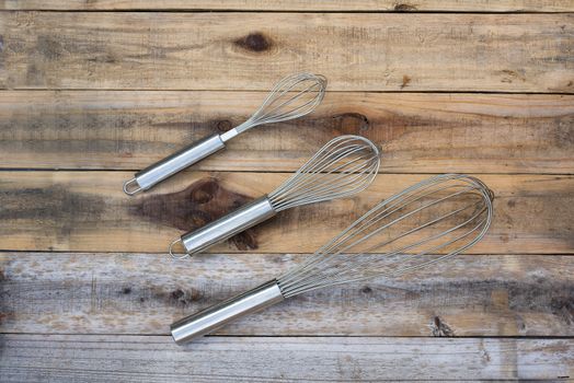 3 whisk different size on wood table