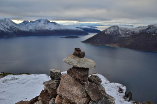 Tourist cairn on the top of the mountain with beautiful background