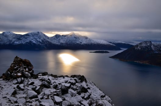 Marvelous sunset from the top of the mountain, there is no sun in the sky only its reflection in the water