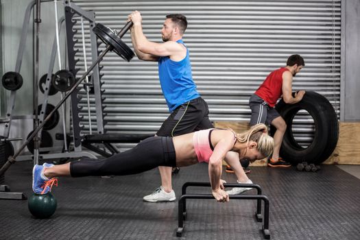 Fit people doing exercises at gym