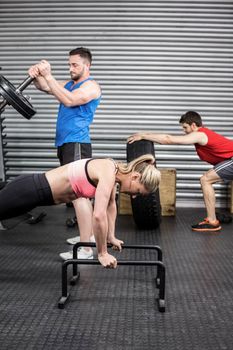 Fit people doing exercises at gym