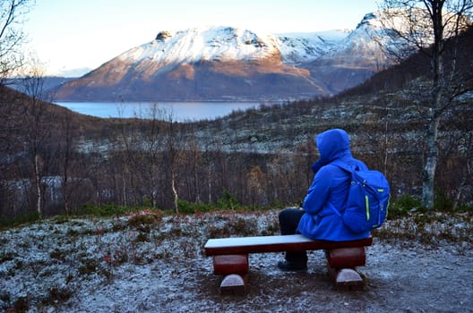 The hiker is taking a rest on his way to the top in Northern Norway