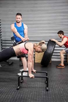 Fit people doing exercises at gym