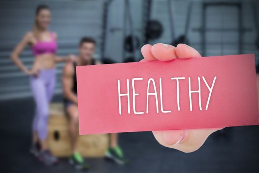 The word healthy and hand showing card against 