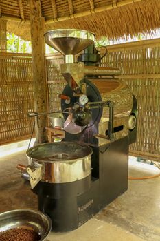 Coffee roasting machine. Professional roasting machine on coffee factory. New modern roasting equipment on coffee farm in Bali, Indonesia. Production of coffee Arabica dan Kopi Luwak.