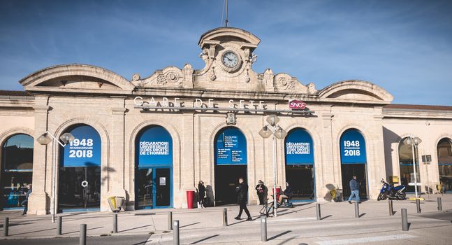 Sete, France - January 4, 2019: People are waiting or walking in front of the SNCF train station under renovation work in the city center on a winter day