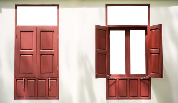 Two red wood twin windows one open one close on white wall background