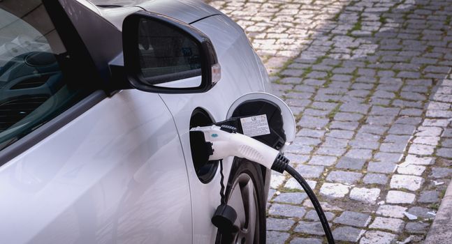 Lisbon, Portugal - May 7, 2018: Electric car in charge in a reserved parking lot of the Nations Park district on a spring day