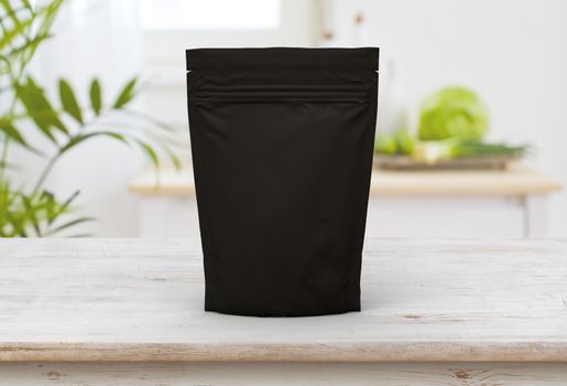 The black food and snack pouch bag packaging mock-up design front view on wooden table 