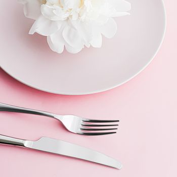 Dining plate and cutlery with peony flower as wedding decor set on pink background, top tableware for event decoration and dessert menu design