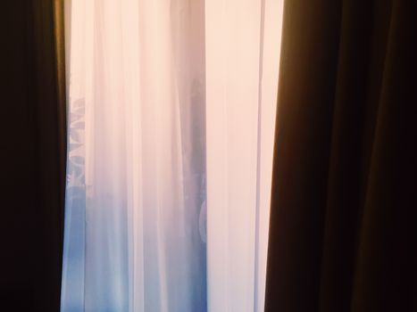 Curtains on window at sunset, furniture and design