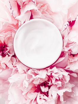 Face cream moisturizer on floral background as luxury skincare cosmetics, healthcare and beauty product concept