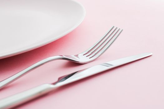Empty plate and cutlery as mockup set on pink background, top tableware for chef table decor and menu branding design