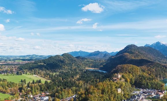 Beautiful nature of European Alps, landscape view of alpine mountains, lake and village on a sunny day, travel and destination scenery