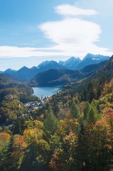 Beautiful nature of European Alps, landscape view of alpine mountains, lake and village on a sunny day, travel and destination scenery