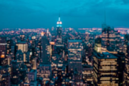 Defocused blurred background of New York city at night. Tourism and city monument concept. Blurred post production for bokeh effect with Orange and teal look