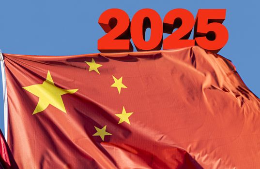 3d text behind the flag of china. Concept of Made in China 2025, a blueprint to upgrade the manufacturing capabilities of Chinese industries into a more technology-intensive powerhouse