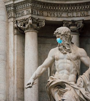 Neptune statue at the trevi fountain with a surgical face mask as a symbol of the Rome lockdown caused by coronavirus outbreak