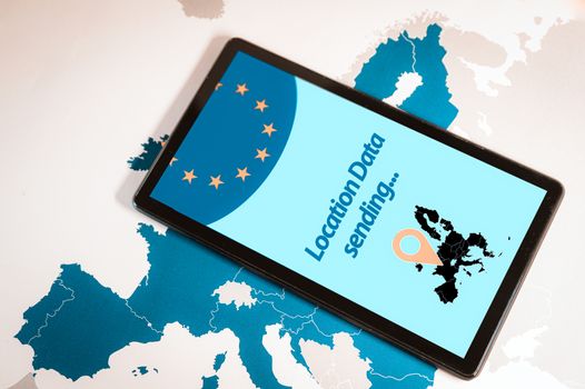 Tablet with location surveillance software on screen over an EU map. Europe may collect smartphone location data to slow virus spread