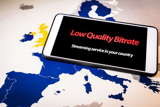Smartphone with low bitrate message on screen over an EU map. The Demand for streaming has increased because large parts of Europe are self-isolating at home due to the coronavirus outbreak.