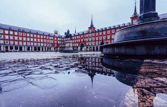 Plaza Mayor of Madrid after the storm, reflected on the ground.