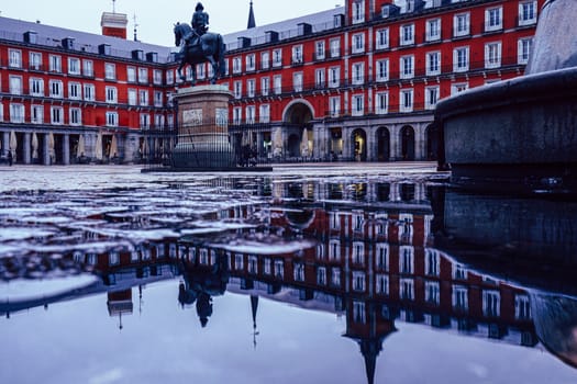 Plaza Mayor of Madrid after the storm, reflected on the ground.