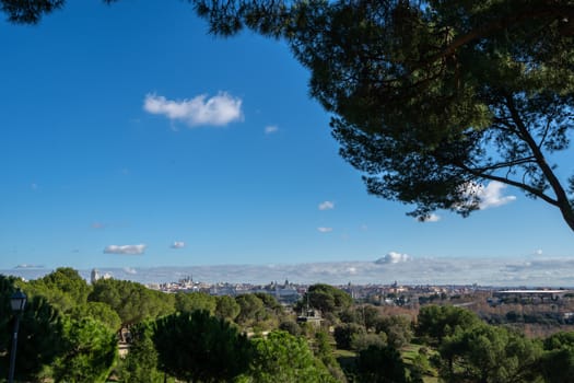 Cable car over casa de campo park and Madrid skyline on the Background.