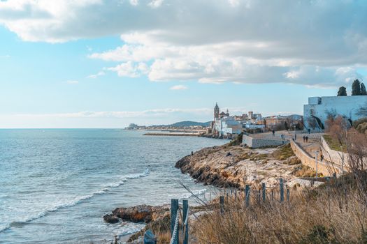 Teal and orange view of the San Sebastian Beach on the mediterranean sea in Sitges, Spain.