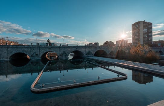 Puente de Segovia or Segovia Bridge on river Manzanares in Madrid, Spain. Teal and orange graded.