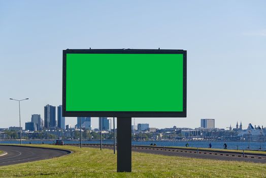 chroma key billboard on a background of cityscape and sea. suitable for advertising. Blank billboard and outdoor advertising. chroma key Mockup poster outside. Tallinn, Estonia