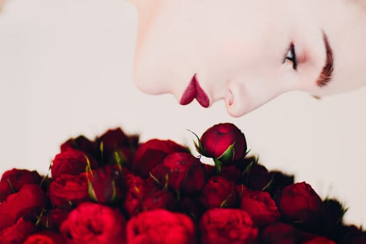 Beautiful woman and red flowers bouguet.