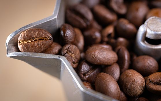 Coffee beans in an italian espresso coffee pot. Morning coffee and relaxing time. Macro shot.