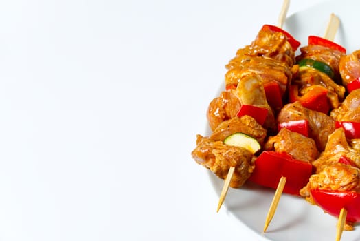 raw marinated meat on wooden skewers, pork, chicken, beef in white plate on white background