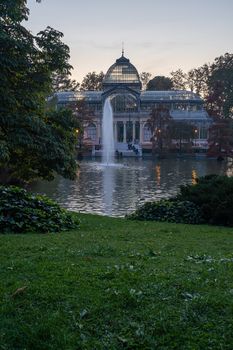 Sunset view of Crystal Palace or Palacio de cristal in Retiro Park in Madrid, Spain. The Buen Retiro Park is one of the largest parks of the city of Madrid, Spain