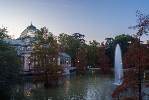 Sunset view of Crystal Palace or Palacio de cristal in Retiro Park in Madrid, Spain. The Buen Retiro Park is one of the largest parks of the city of Madrid, Spain