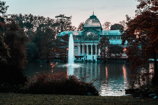 Sunset view of Crystal Palace or Palacio de cristal in Retiro Park in Madrid, Spain. The Buen Retiro Park is one of the largest parks of the city of Madrid, Spain