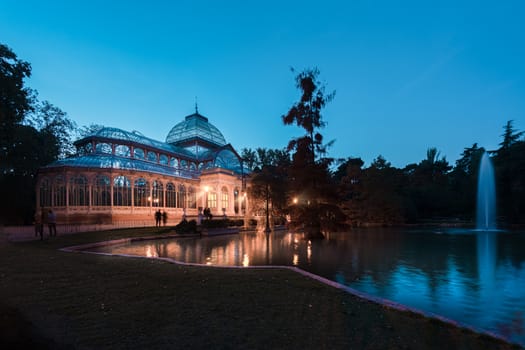 Blue hour view of Crystal Palace or Palacio de cristal in Retiro Park in Madrid, Spain. The Buen Retiro Park is one of the largest parks of the city of Madrid, Spain