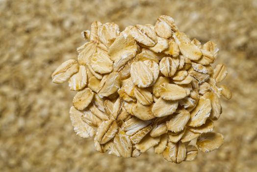 Close up of oats flakes. oats flakes macro shoot. Oatmeal flakes texture. Background of golden oat flakes. Healthy food