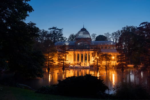 Night view of Crystal Palace or Palacio de cristal in Retiro Park in Madrid, Spain. The Buen Retiro Park is one of the largest parks of the city of Madrid, Spain