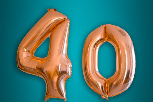 Isolated pink gold Helium Balloon in the shape of the number 40. Suitable for forty years celebration or anniversary , 40 billboard or 40 percent discount.