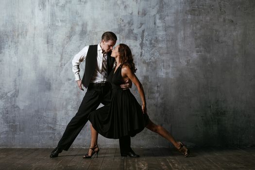 Dancers in black dress dancing tango