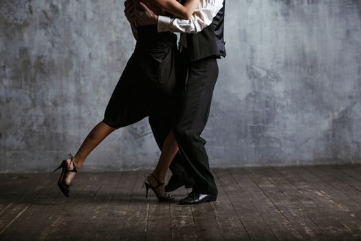 Young pretty woman in black dress and man dance valse